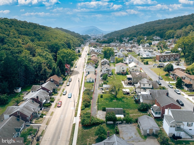 aerial view with a residential view, a mountain view, and a view of trees