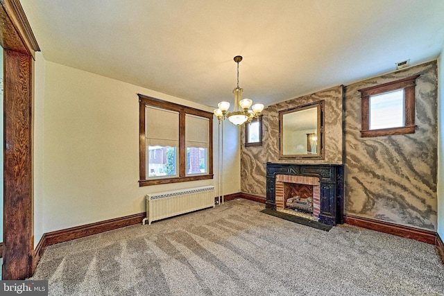 unfurnished living room featuring radiator heating unit, baseboards, carpet flooring, and a fireplace with flush hearth