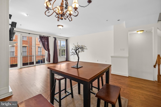 dining area with an inviting chandelier and wood finished floors