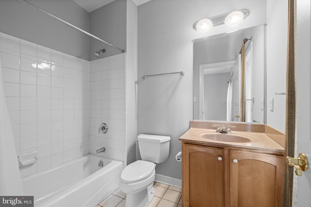 full bathroom featuring baseboards, toilet, tile patterned flooring, vanity, and shower / washtub combination