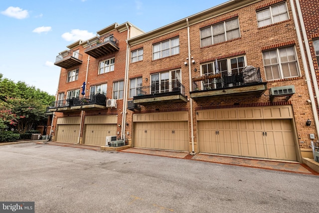 view of property with a garage and central air condition unit