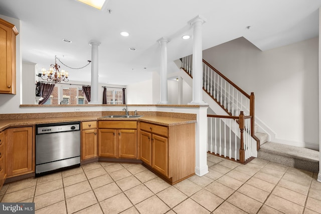 kitchen with dishwasher, a peninsula, a sink, and decorative columns