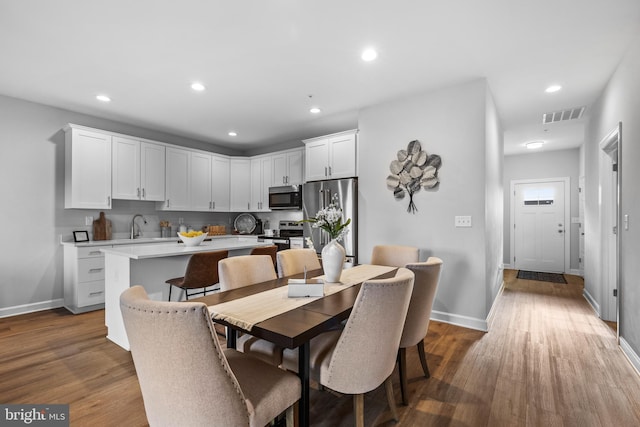 dining space with dark hardwood / wood-style floors and sink