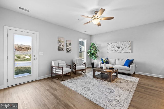 living room with ceiling fan and wood-type flooring