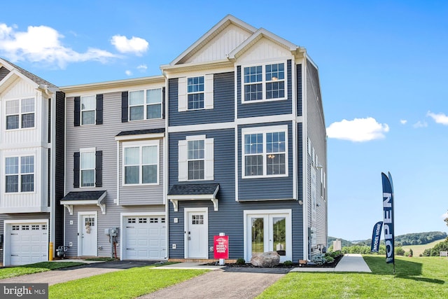 multi unit property with a front yard and a garage