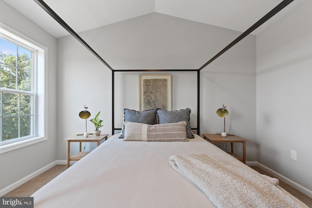 bedroom with carpet floors and lofted ceiling