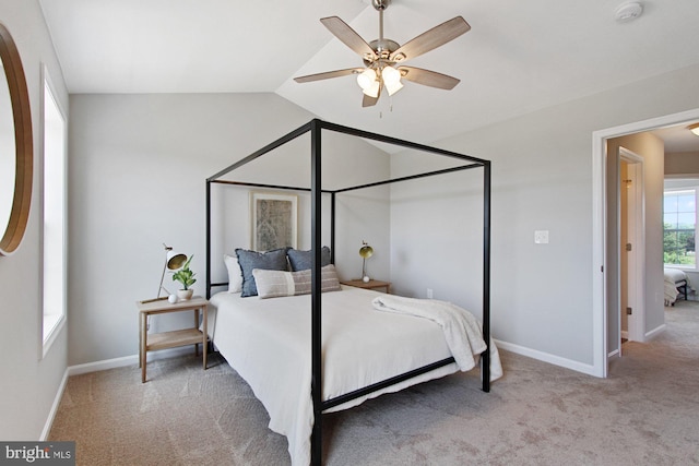 carpeted bedroom with ceiling fan and vaulted ceiling