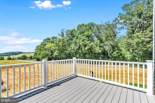 wooden deck with a lawn