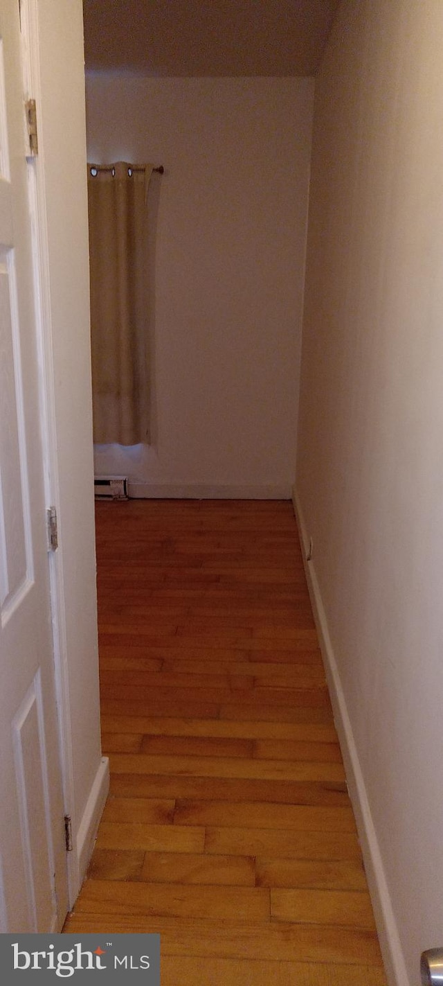 hallway featuring light hardwood / wood-style flooring and a baseboard radiator