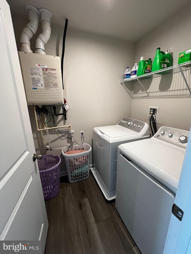 washroom featuring washing machine and dryer, dark hardwood / wood-style floors, and water heater