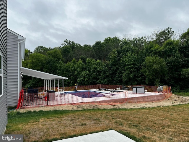 view of swimming pool with a yard and a patio