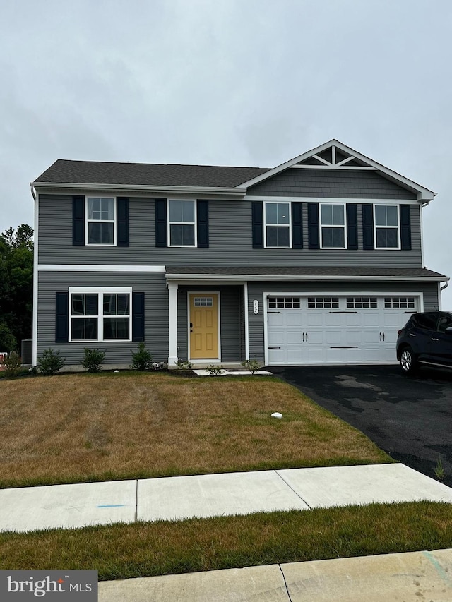 view of front facade with a front yard and a garage