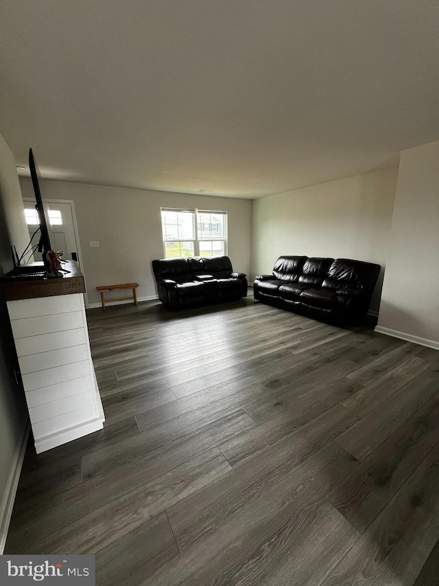 unfurnished living room with dark hardwood / wood-style flooring