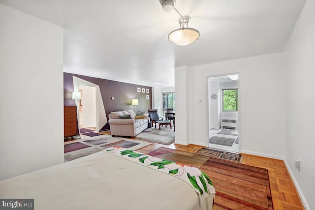 bedroom with radiator heating unit and parquet floors