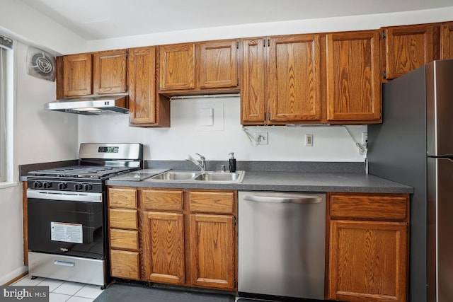 kitchen with light tile patterned flooring, appliances with stainless steel finishes, and sink