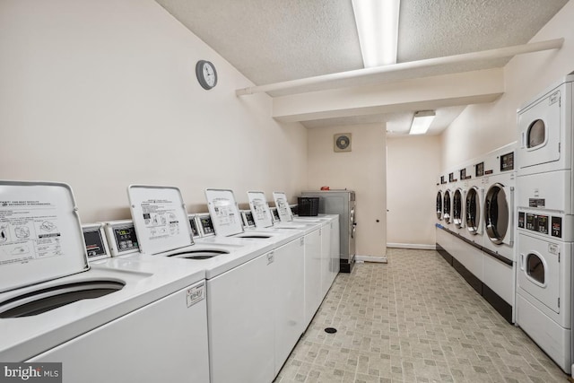 washroom featuring stacked washer / dryer, a textured ceiling, and independent washer and dryer