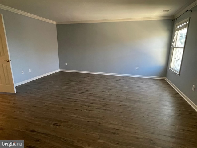 spare room with crown molding and dark wood-type flooring