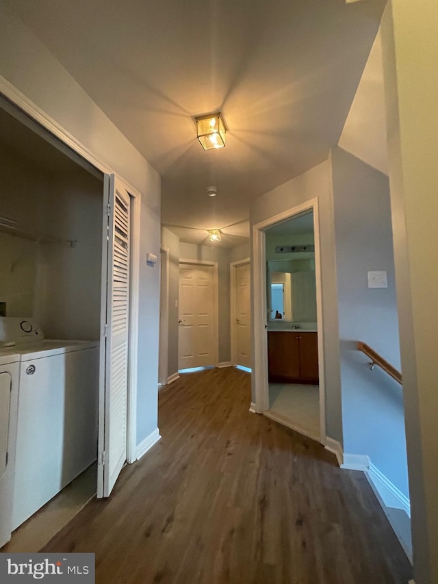 hallway featuring dark hardwood / wood-style flooring and washer and clothes dryer