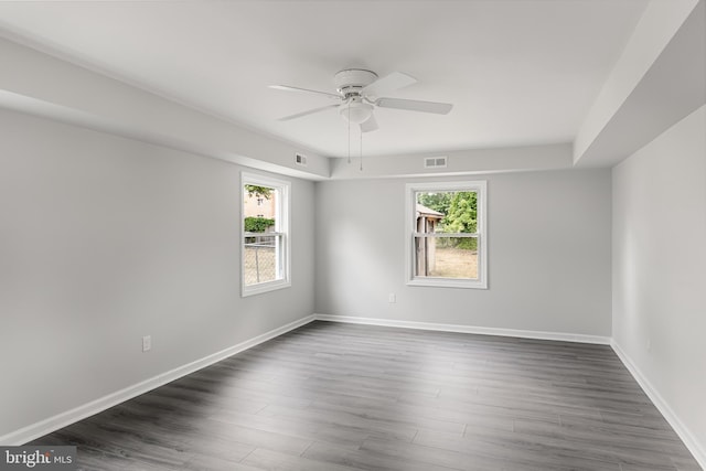 spare room with ceiling fan and dark hardwood / wood-style flooring