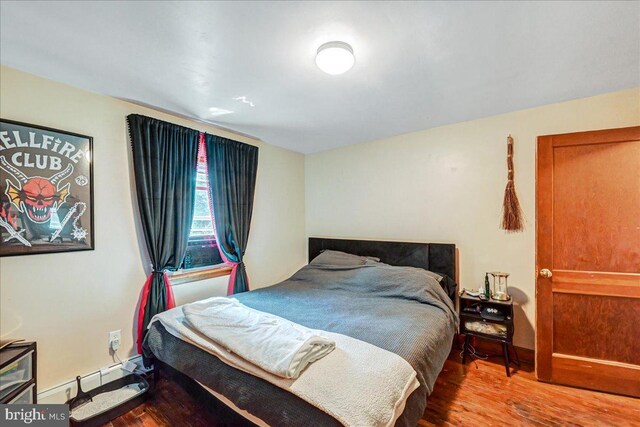 bedroom with hardwood / wood-style floors