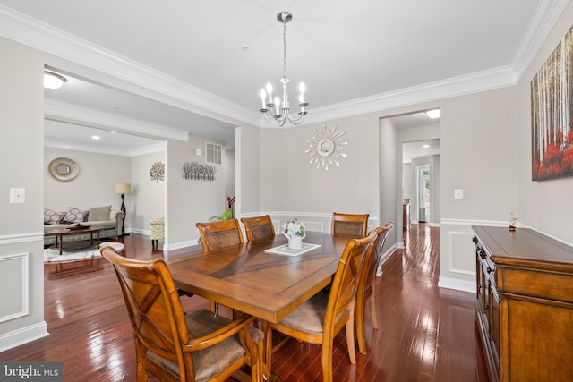 dining room with dark wood-style floors, visible vents, a notable chandelier, and ornamental molding
