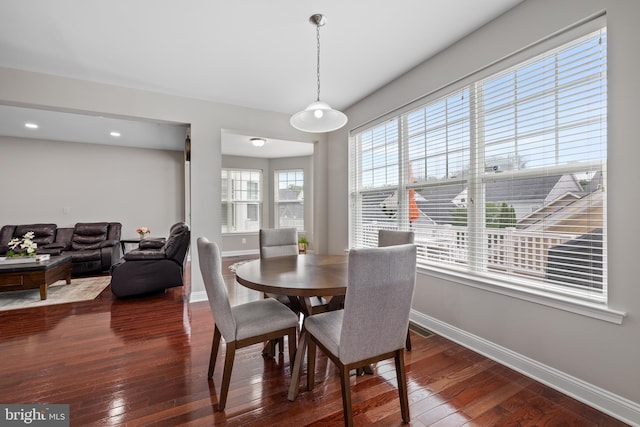 dining space with recessed lighting, wood finished floors, and baseboards