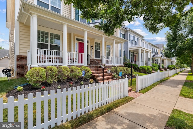 view of front of property with covered porch and brick siding
