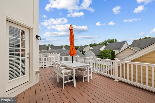 wooden deck with outdoor dining space and a residential view