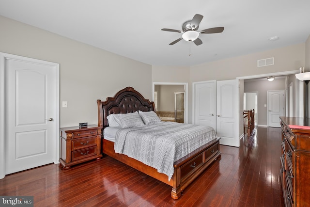 bedroom featuring a ceiling fan, dark wood-style flooring, visible vents, and ensuite bathroom