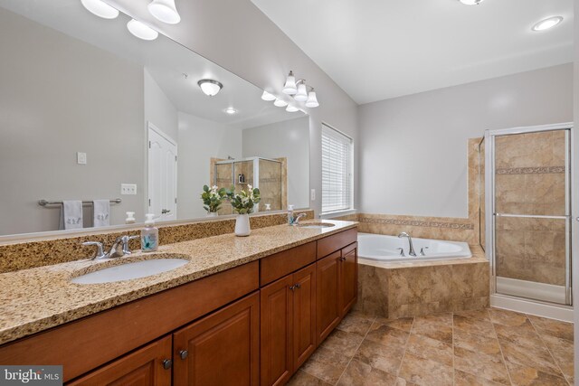 full bath featuring a stall shower, a garden tub, a sink, and double vanity