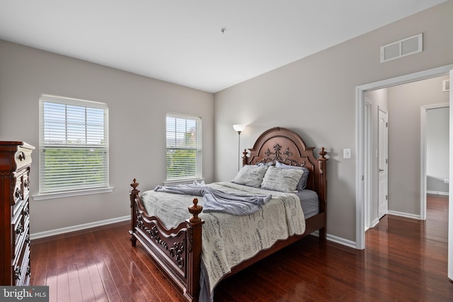 bedroom featuring baseboards, visible vents, and dark wood-style flooring