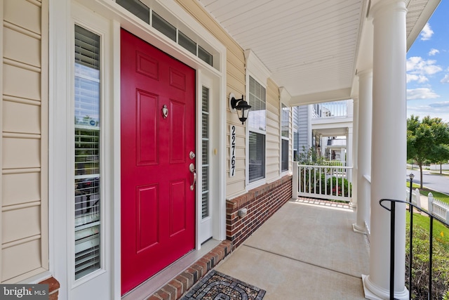 view of exterior entry featuring brick siding