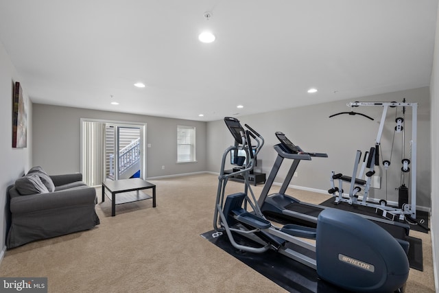 exercise room featuring light carpet, baseboards, and recessed lighting