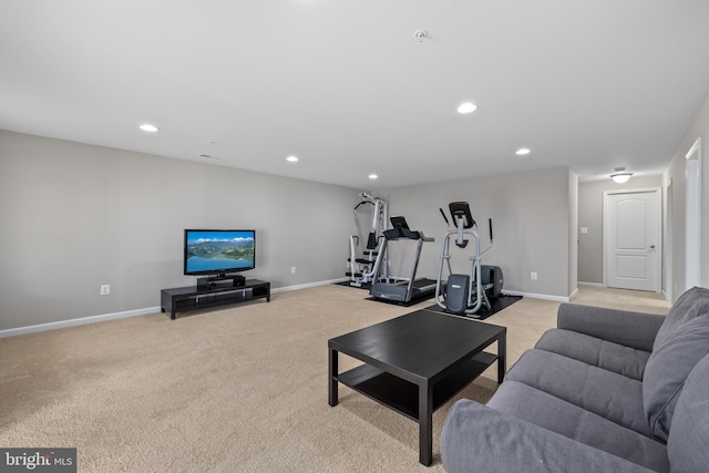 living room featuring baseboards, light colored carpet, and recessed lighting