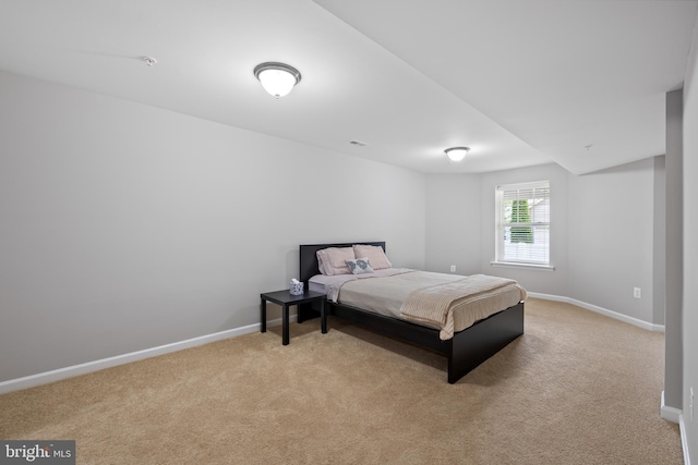 bedroom with visible vents, baseboards, and light colored carpet