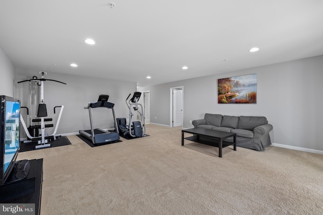 exercise area featuring recessed lighting, light colored carpet, and baseboards