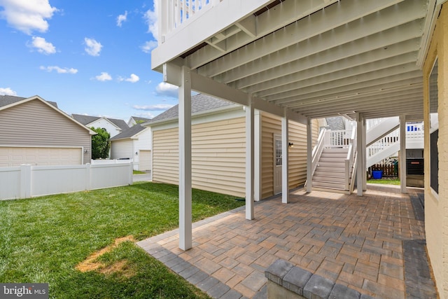 view of patio with fence and stairs
