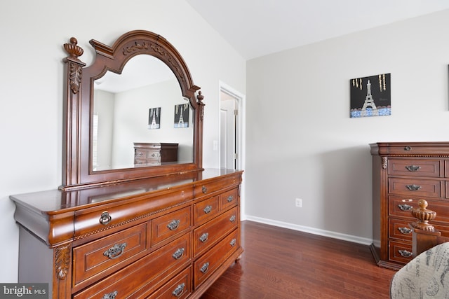 bedroom with dark wood-style floors and baseboards