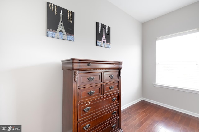 bedroom featuring baseboards and dark wood-type flooring