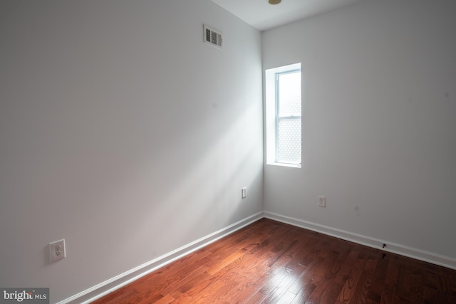 empty room featuring dark hardwood / wood-style floors