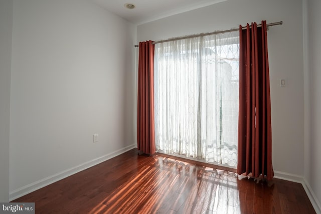 unfurnished room with dark hardwood / wood-style floors