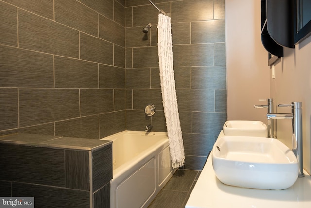 bathroom featuring shower / tub combo, sink, and tile patterned flooring