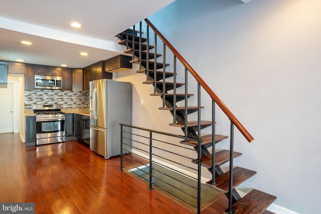 stairway featuring wood-type flooring