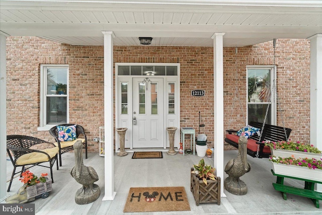 property entrance with covered porch