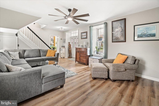 living room featuring ceiling fan and light hardwood / wood-style floors