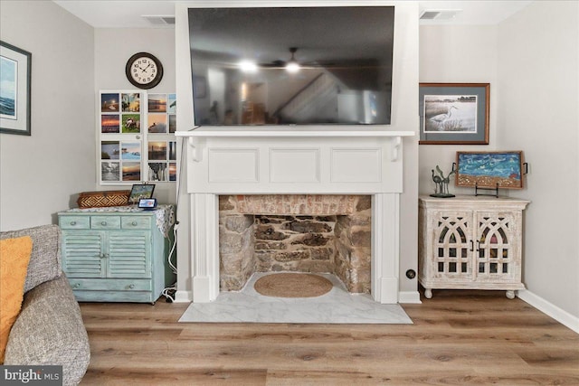 living room with wood-type flooring and a fireplace