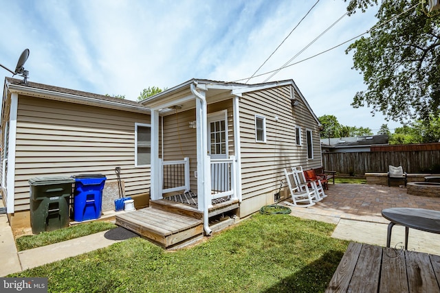 rear view of house with a patio area and a yard