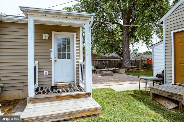 doorway to property featuring a yard and a patio