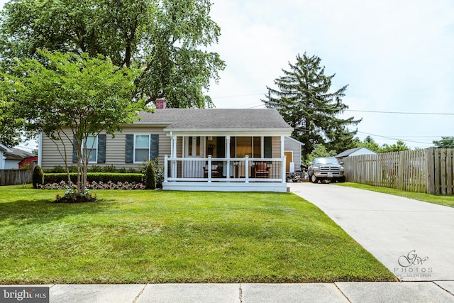 rear view of property with a lawn and a porch