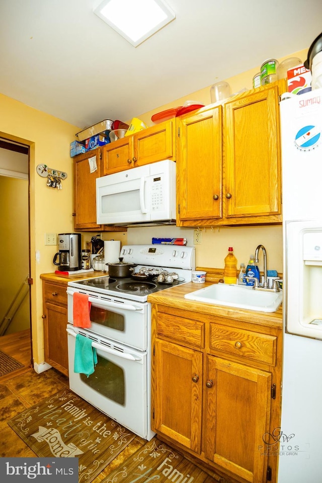 kitchen with sink and white appliances